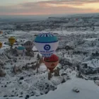 Hot air balloons over Cappadocia on a snowy day Nazar Balloons