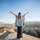 young-happy-woman-traveler-enjoying-vacation-cappadocia-turkiye