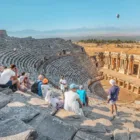 Theater at pamukkale with tourists sitting there